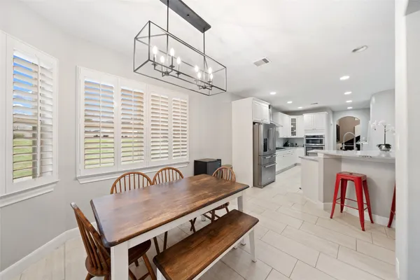 a spacious bedroom with a bed and a flat screen tv