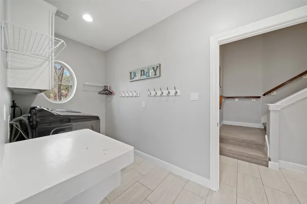 a bathroom with a granite countertop sink a mirror a glass door and shower