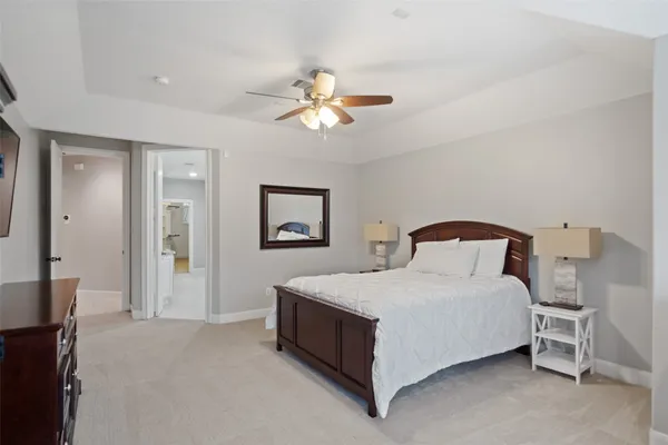 a living room with furniture and a ceiling fan