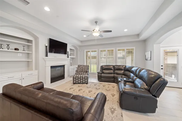 a kitchen with white cabinets and window