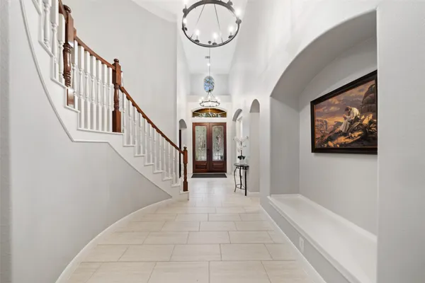 a view of a dining room with furniture a chandelier and wooden floor