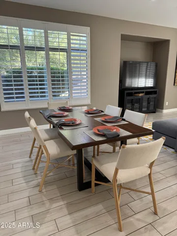 a view of a dining room with furniture and a table
