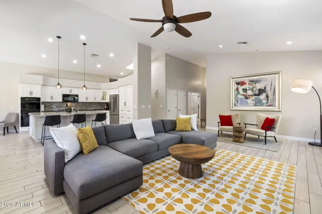 a kitchen with stainless steel appliances kitchen island granite countertop a stove a sink and a white cabinets