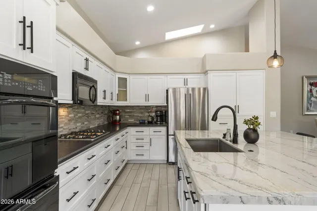 a dining room with furniture a chandelier and wooden floor