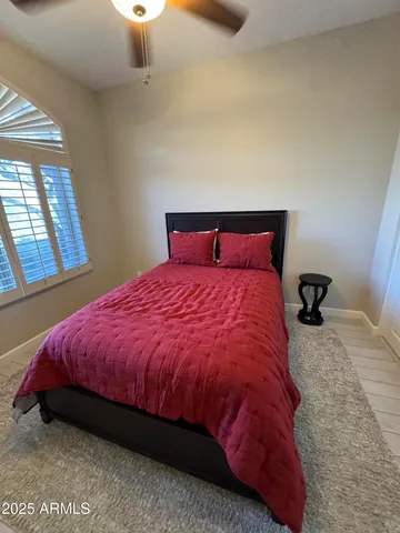 a large bed sitting in a bedroom next to a window
