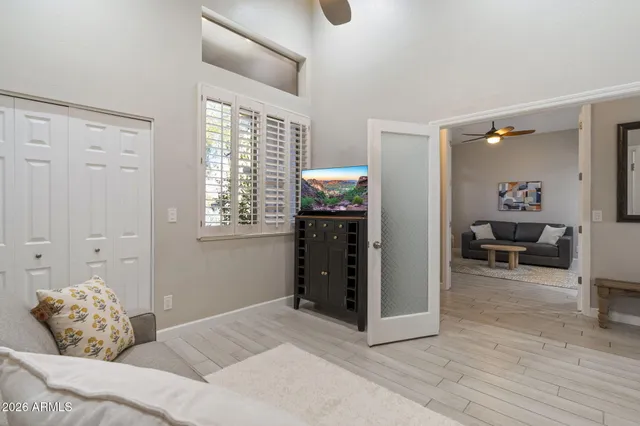 a spacious bedroom with a large bed and a chandelier