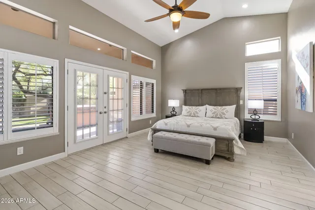 a spacious bedroom with a bed and a chandelier