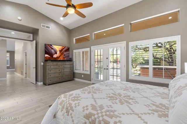 a spacious bathroom with a double vanity sink a mirror and a bathtub