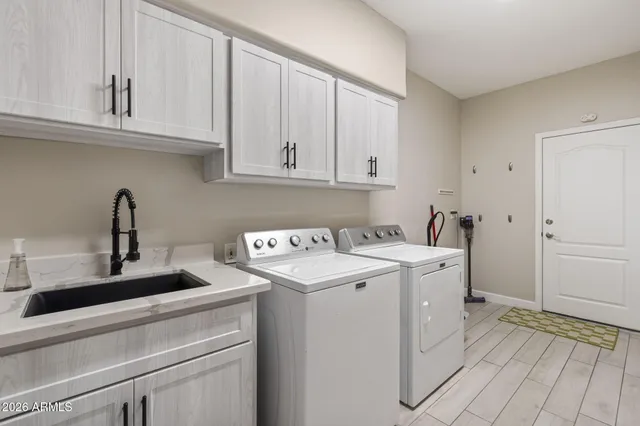 a living room with furniture a chandelier and a fireplace