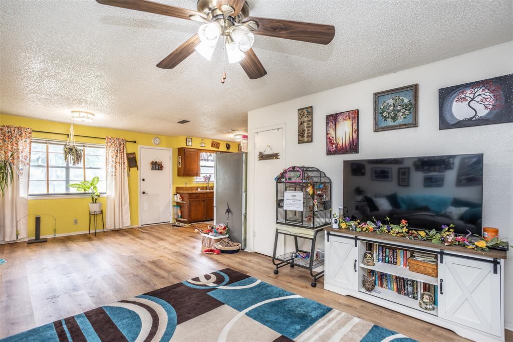 2212 North Aspen Road Gainesville, TX 76240 - Photo 5 of 34 a living room with furniture and wooden floor