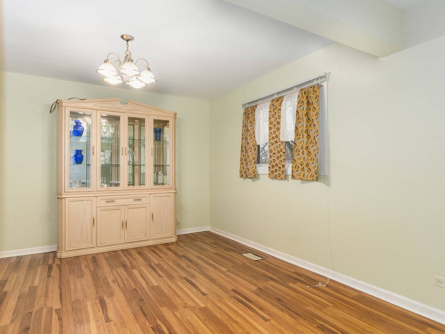 410 Aster Lane Hoffman Estates, IL 60169 - Photo 5 of 12 a view of an empty room with wooden floor and a window