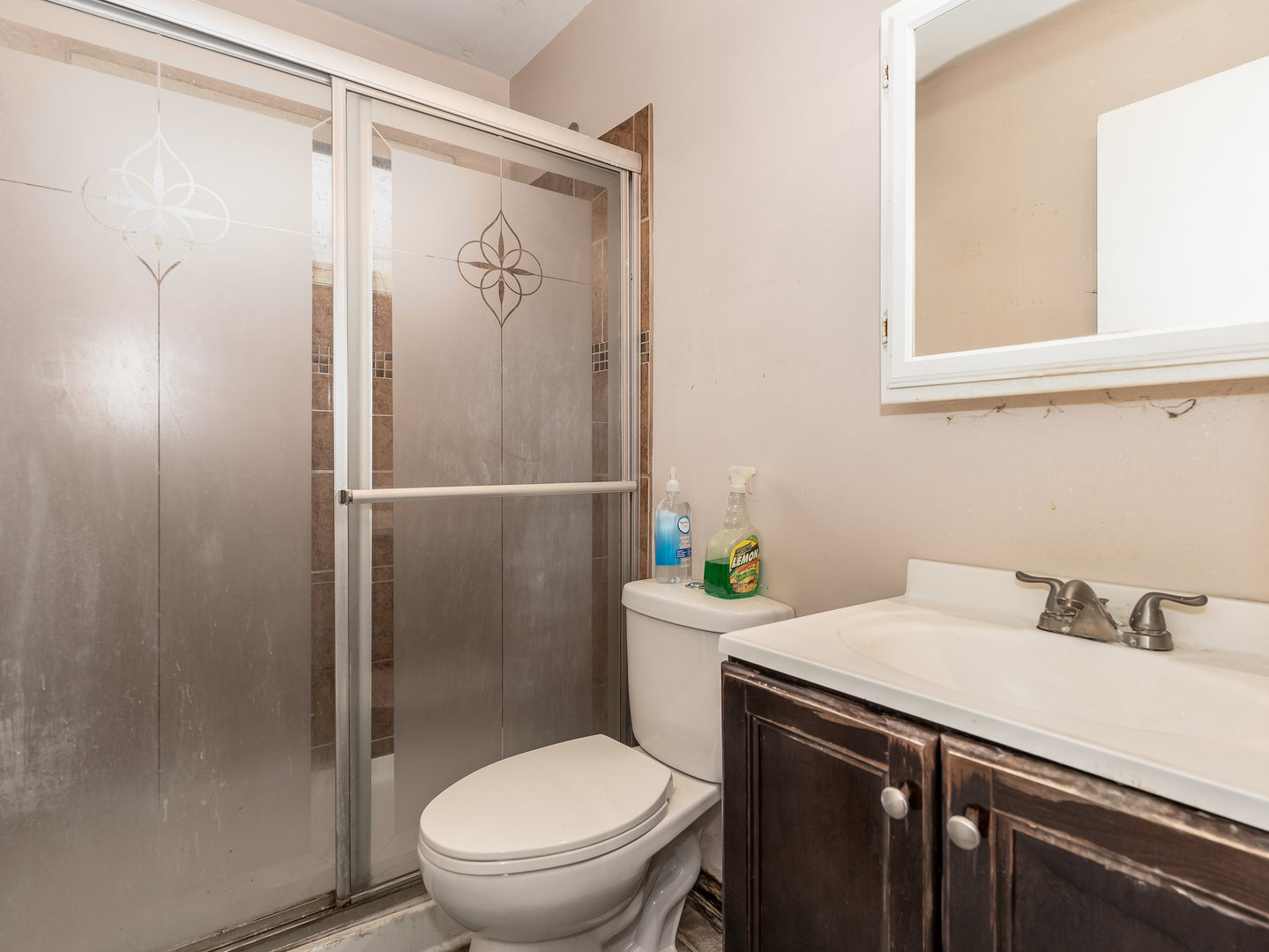 410 Aster Lane Hoffman Estates, IL 60169 - Photo 10 of 12 a bathroom with a sink a toilet and shower