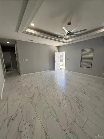 a view of an empty room with a ceiling fan