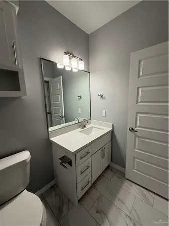 a bathroom with a double vanity sink and a toilet