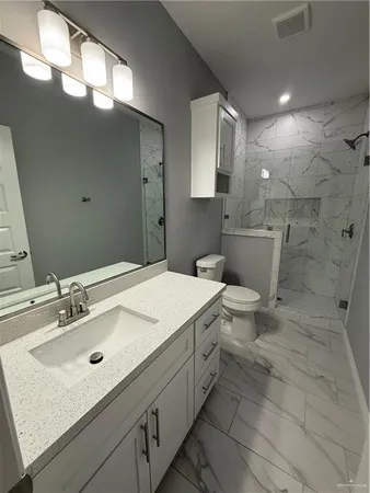 a bathroom with a sink toilet and mirror