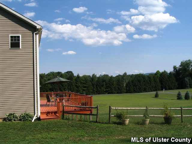 65 Peak Road, Unit HOME WARRANTY IN PLACE Stone Ridge, NY 12484 - Photo 4 of 6 a view of a lake with a yard
