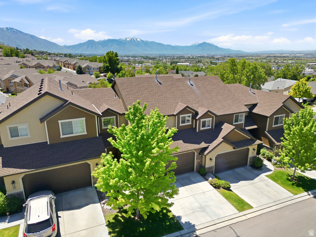 1614 Aspen Loop Provo, UT 84606 - Photo 2 of 47 Multi-level townhome featuring a brown shingle roof and a two-car garage