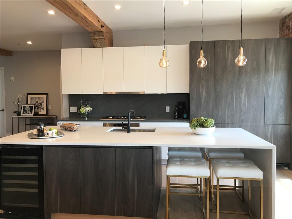 a kitchen with a sink cabinets and wooden floor