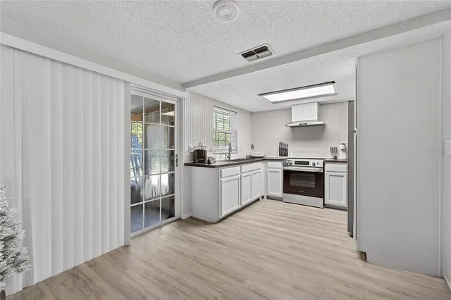 a kitchen with cabinets appliances and a window