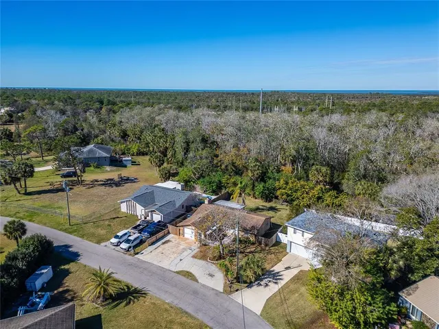 an aerial view of a house with a yard