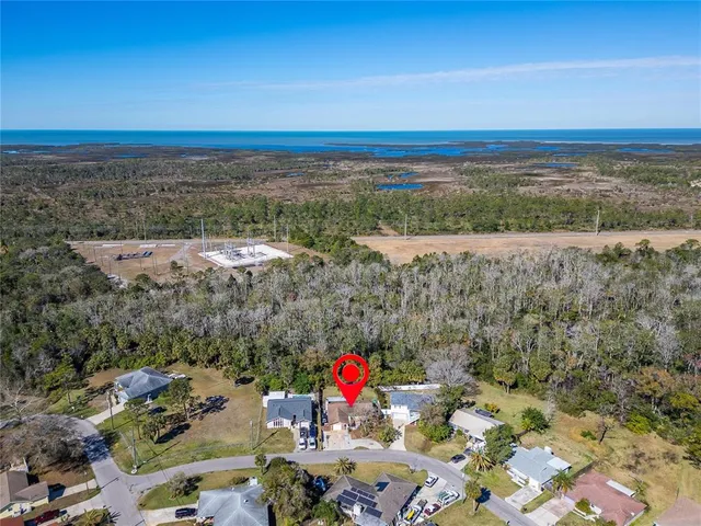 an aerial view of a house with a yard swimming pool and outdoor seating