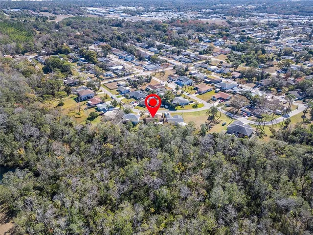an aerial view of a house with a swimming pool yard and outdoor seating