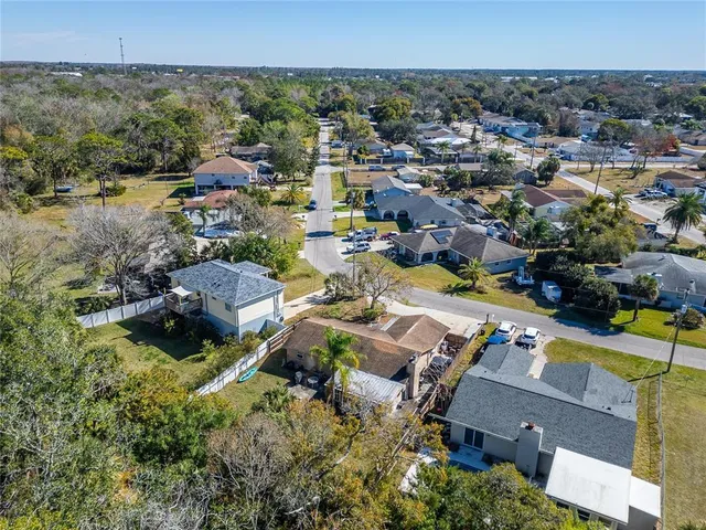 an aerial view of residential houses with outdoor space