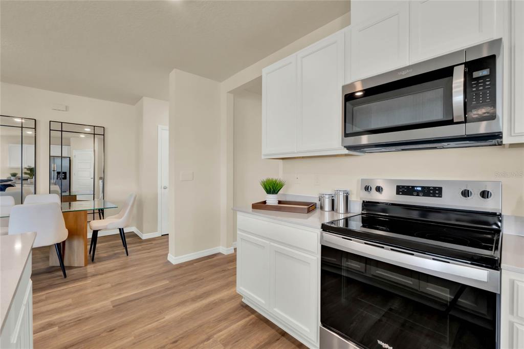 3517 Nettle Loop Tavares, FL 32778 - Photo 13 of 27 a kitchen with a stove and a microwave