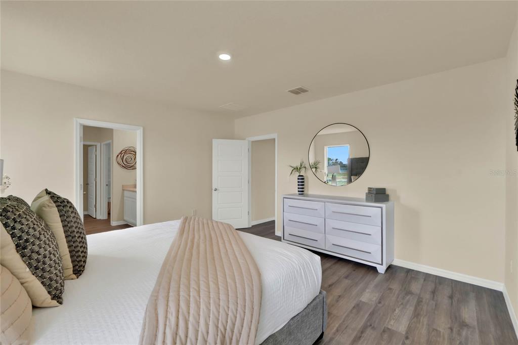 3517 Nettle Loop Tavares, FL 32778 - Photo 16 of 27 a bedroom with a bed and a dresser