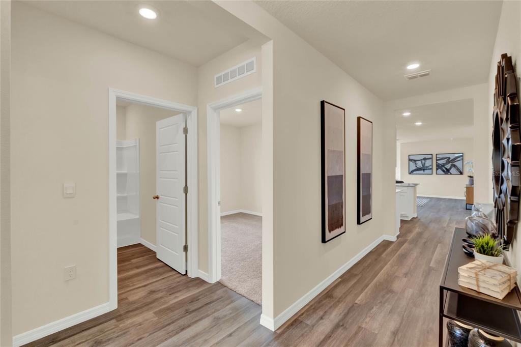 3517 Nettle Loop Tavares, FL 32778 - Photo 3 of 27 a view of a hallway with wooden floor and furniture