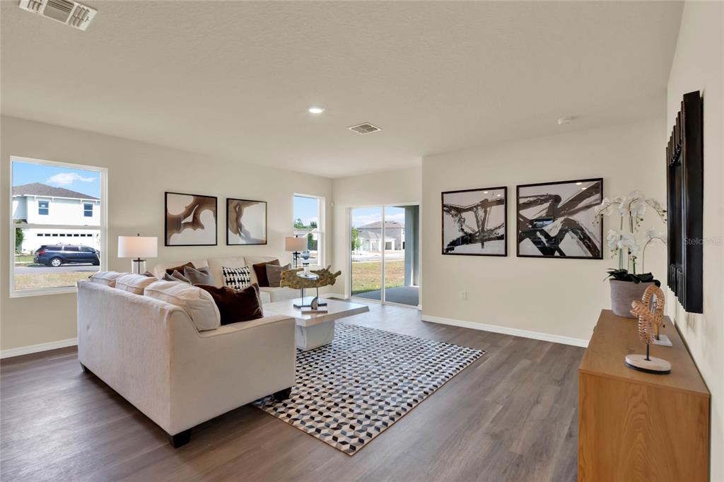 3517 Nettle Loop Tavares, FL 32778 - Photo 4 of 27 a living room with furniture and a wooden floor