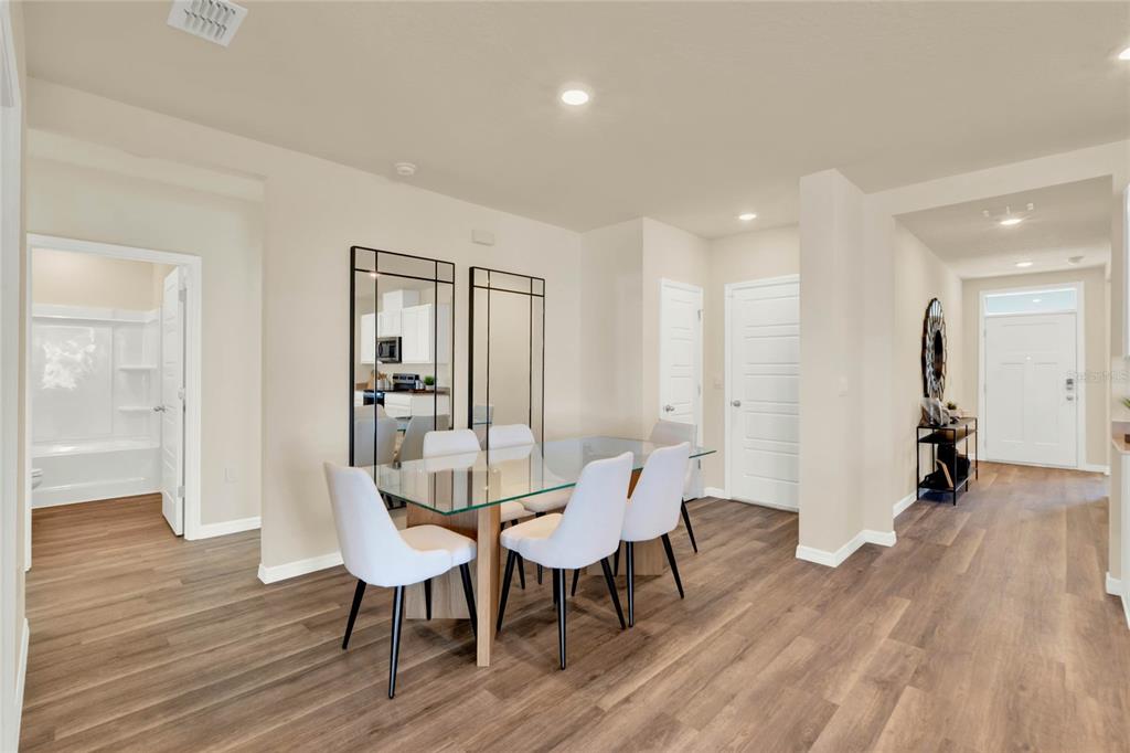 3517 Nettle Loop Tavares, FL 32778 - Photo 8 of 27 a view of a dining room with furniture and wooden floor