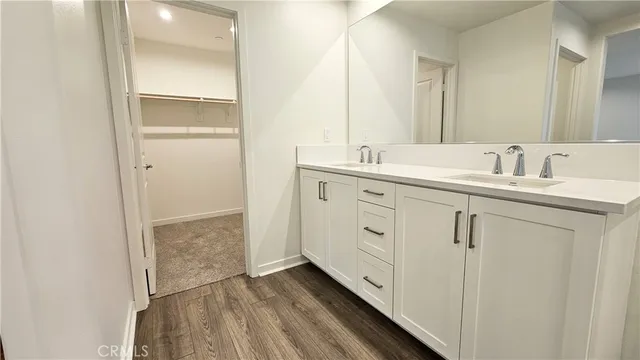 a bathroom with a double vanity sink and mirror