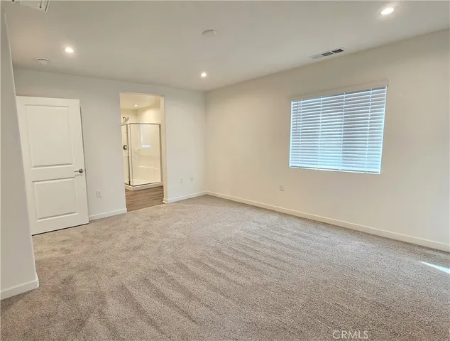 an empty room with windows and closet