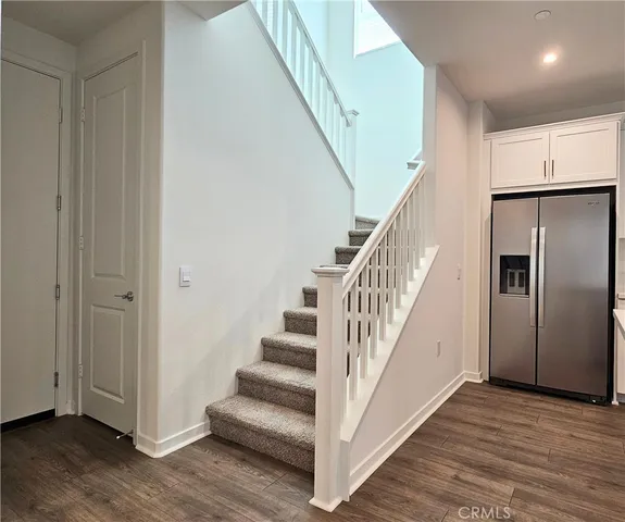 a view of a hallway with wooden floor and entryway