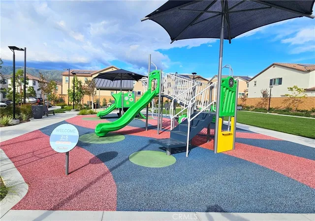 a view of a swimming pool with a table and chairs under an umbrella