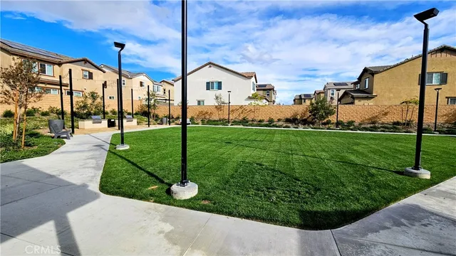 a view of a house with a yard and potted plants