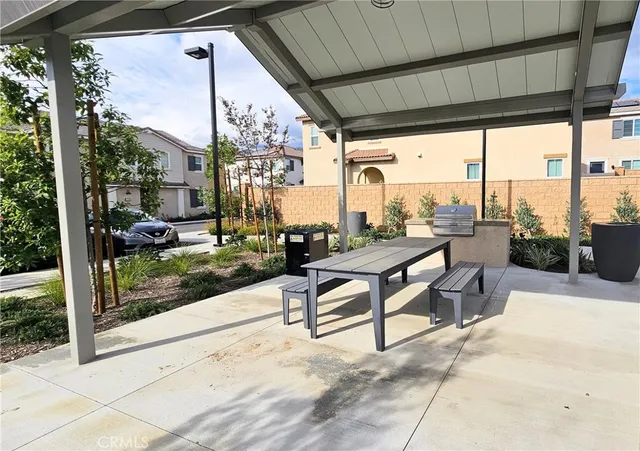 a view of a patio with a dining table and chairs