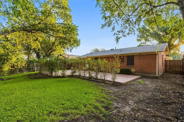 a view of a house with a yard and sitting area