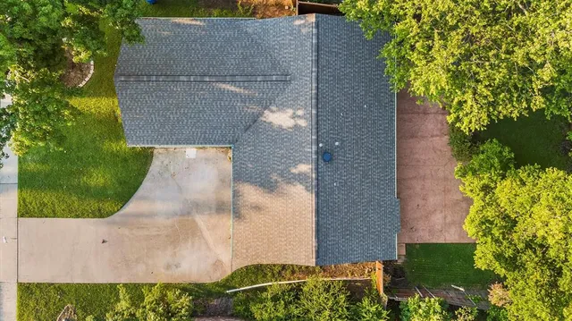 an aerial view of a house with a yard