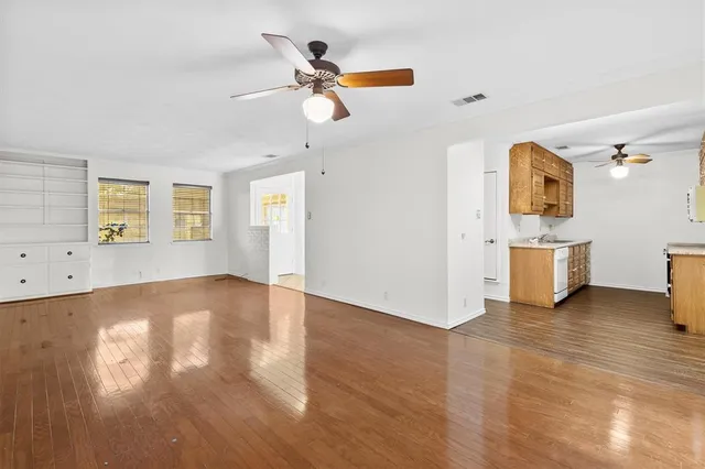 a view of a kitchen with a sink hardwood floor and a ceiling fan