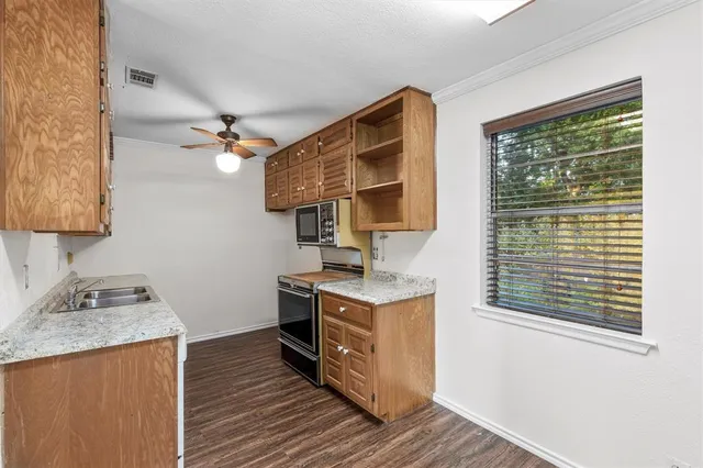 a kitchen with a stove and a sink