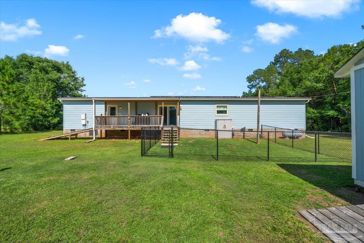 4955 Blue Ribbon Drive Milton, FL 32583 - Photo 26 of 32 a view of house with backyard and outdoor seating