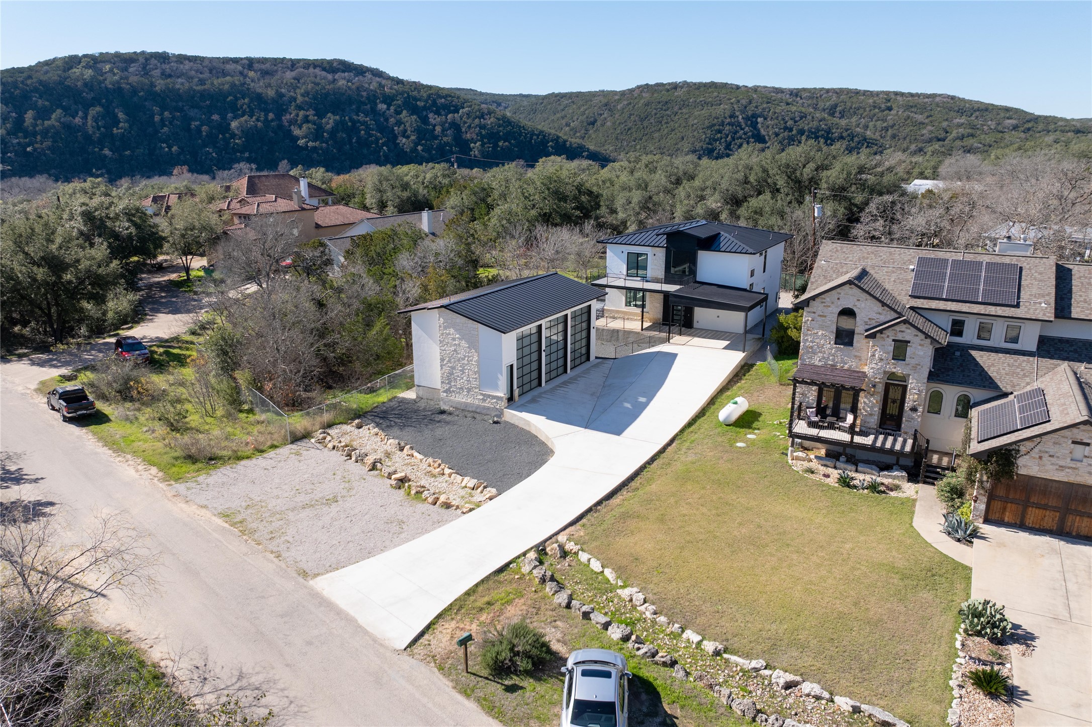 1304 Minnie Drive Austin, TX 78732 - Photo 1 of 28 Drone / aerial view of mountains