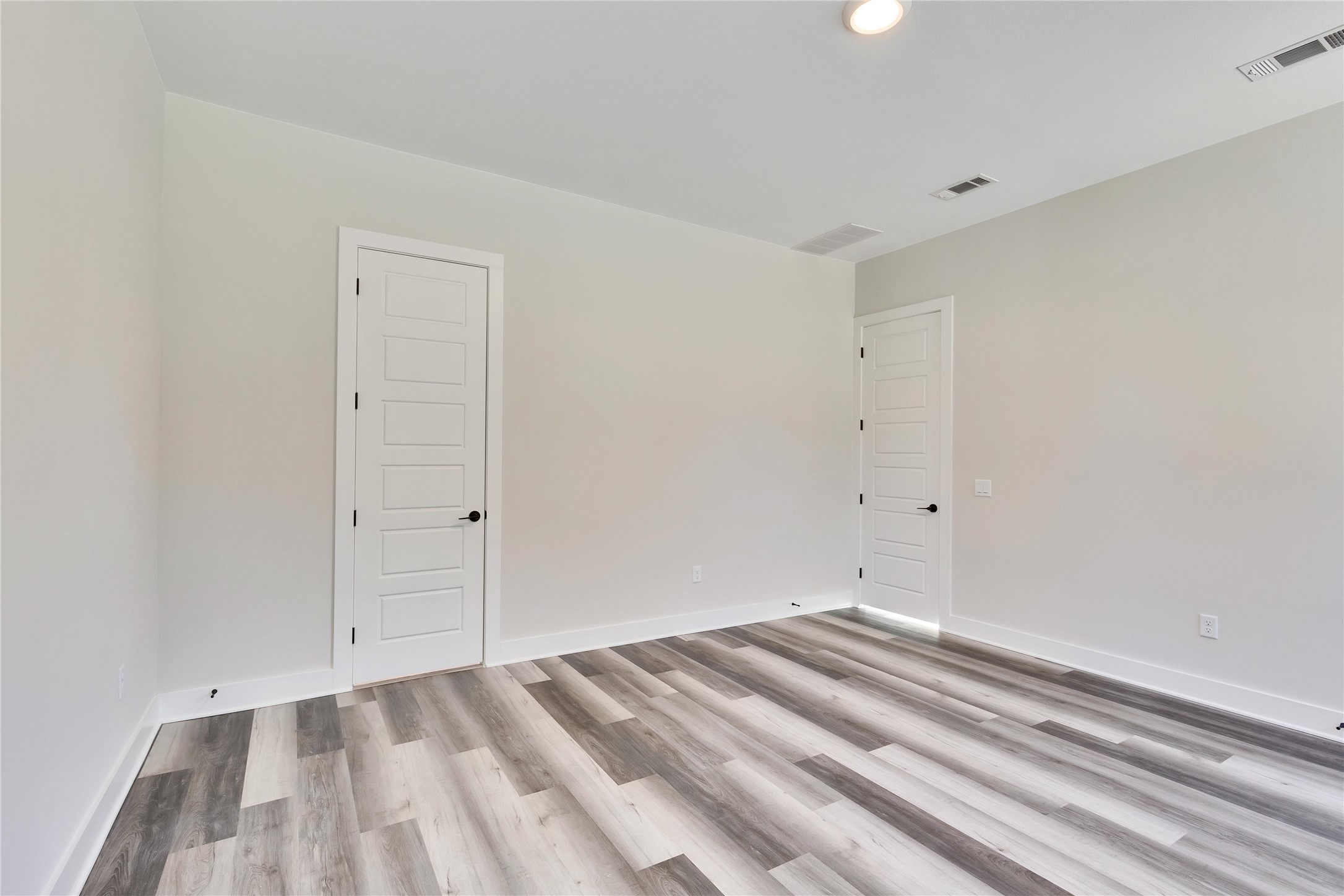 1304 Minnie Drive Austin, TX 78732 - Photo 15 of 28 Empty room featuring light wood-type flooring and baseboards