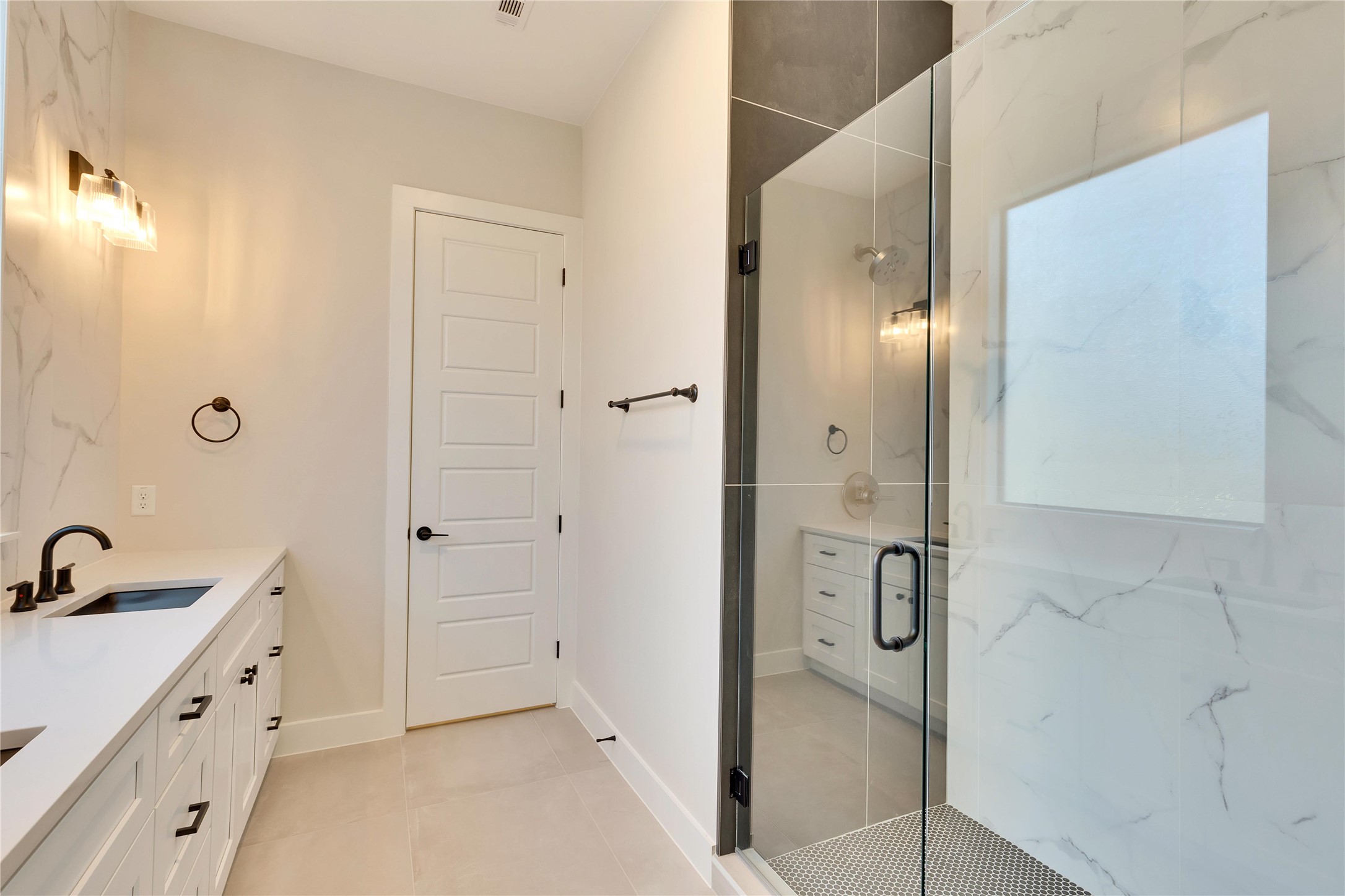 1304 Minnie Drive Austin, TX 78732 - Photo 17 of 28 Full bath featuring vanity, a marble finish shower, and light tile patterned floors
