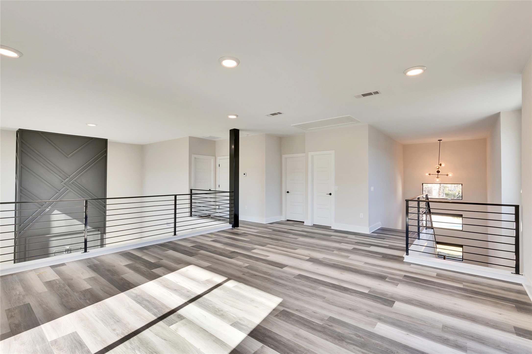 1304 Minnie Drive Austin, TX 78732 - Photo 20 of 28 Spare room featuring light wood-style floors and recessed lighting
