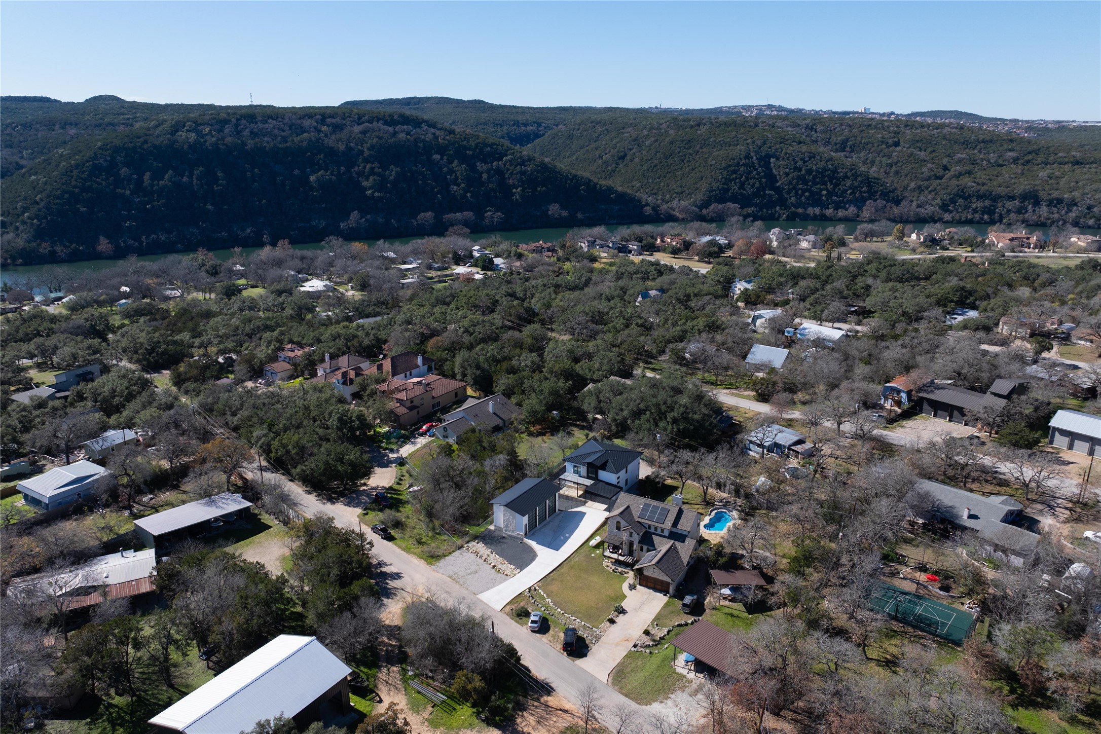 1304 Minnie Drive Austin, TX 78732 - Photo 2 of 28 Aerial overview of property's location featuring mountains and nearby suburban area