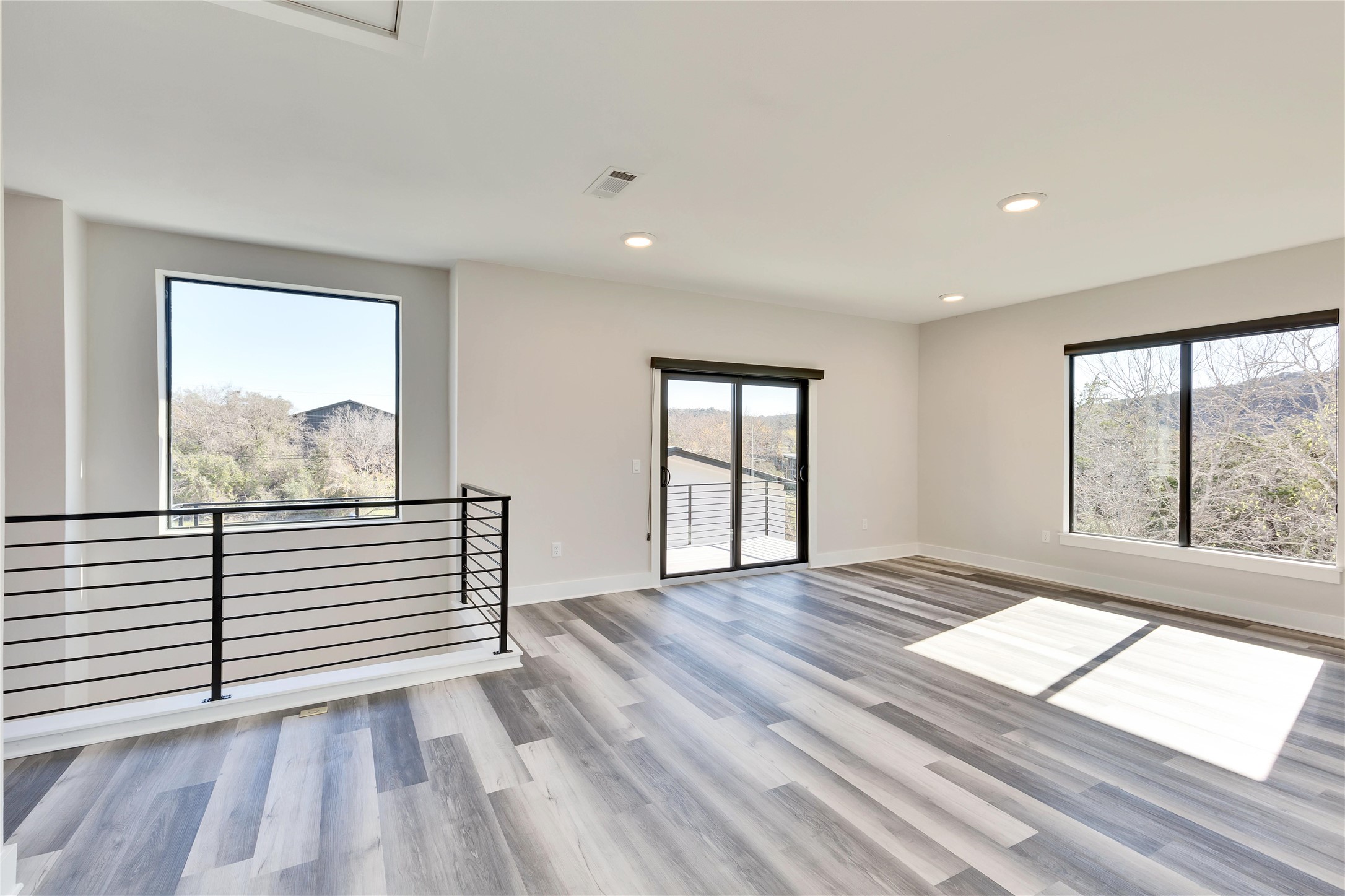 1304 Minnie Drive Austin, TX 78732 - Photo 21 of 28 Empty room featuring light wood-style flooring and recessed lighting