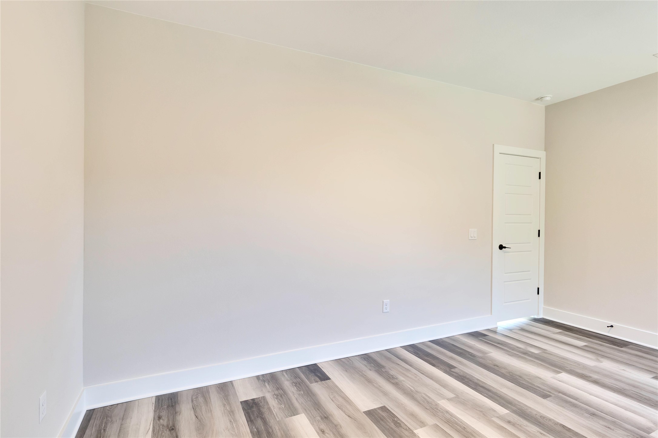 1304 Minnie Drive Austin, TX 78732 - Photo 24 of 28 Empty room featuring light wood-type flooring and baseboards